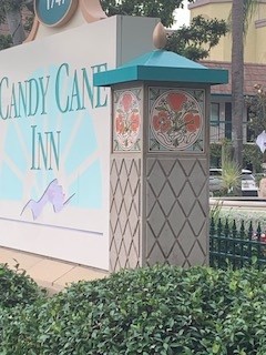 Floral tile displayed on a concrete column at the Candy Cane Inn sign in Anaheim, California.