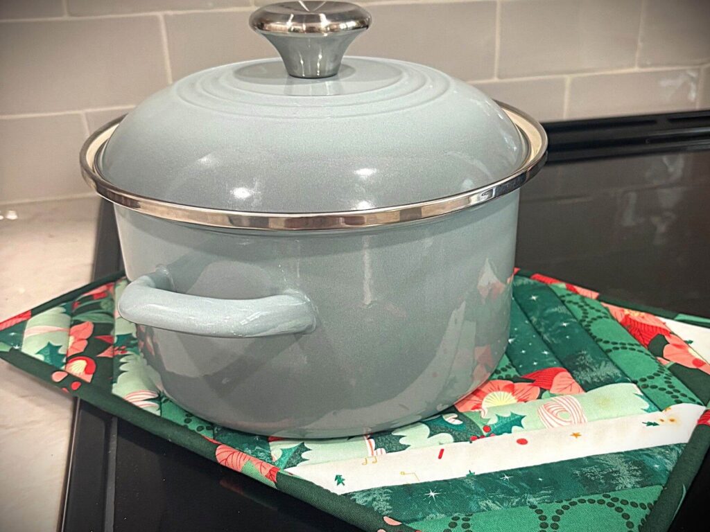 Quilted casserole hot pad with a hot pot