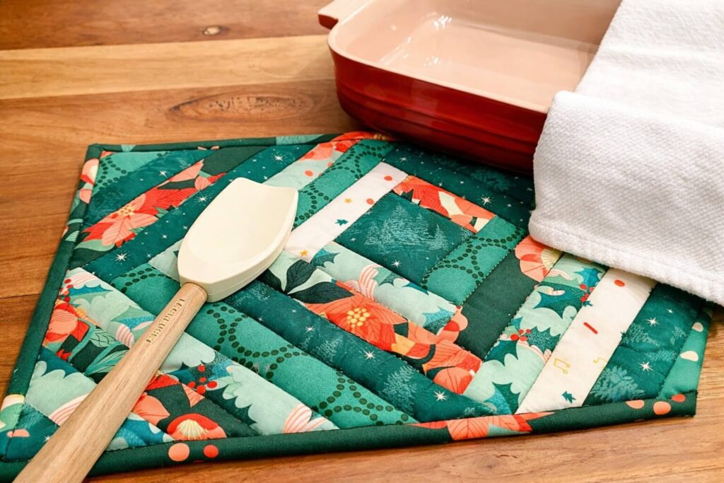Styled quilted casserole hot pad on kitchen table