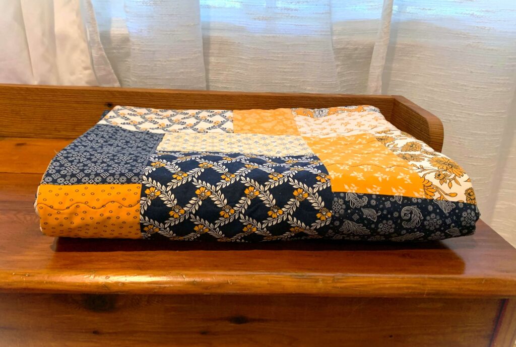 Folded quilt showing layered fabfics
