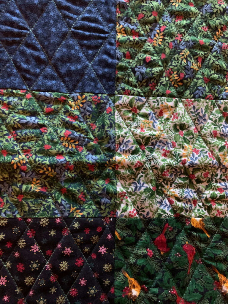 Close-up of crosshatch quilting on a patchwork table topper